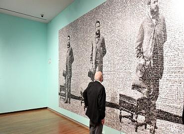 Visitor in front of artwork displayed on the Aga Khan Museum wall at the Image? The Power of The Visual exhibition.